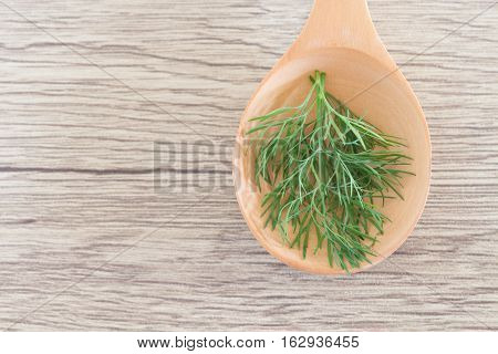 Green Herb Powder Capsules On Wooden Spoon