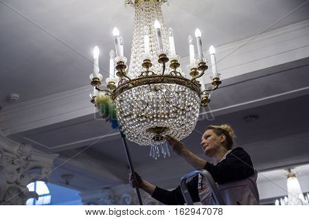 A Woman Worker Looks Like The Dust From The Chandeliers