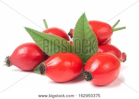 heap of fresh rose hip berry with leaves isolated on white background.
