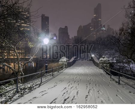 Gapstow Bridge is one of the icons of Central Park Manhattan in New York City during snow storm at night