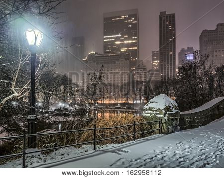 Gapstow Bridge is one of the icons of Central Park Manhattan in New York City during snow storm at night