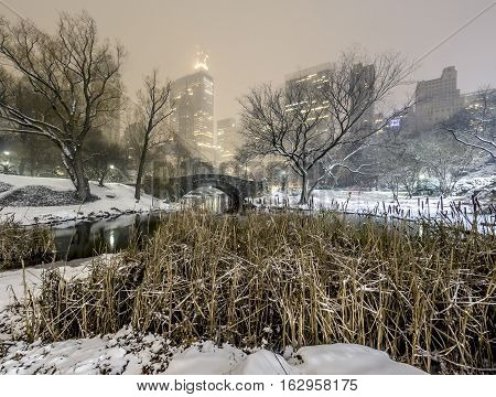 Gapstow Bridge is one of the icons of Central Park Manhattan in New York City during snow storm at night
