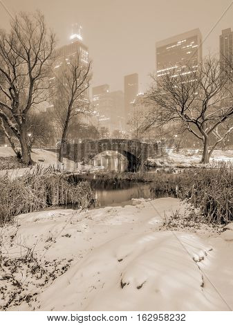 Gapstow Bridge is one of the icons of Central Park Manhattan in New York City during snow storm at night
