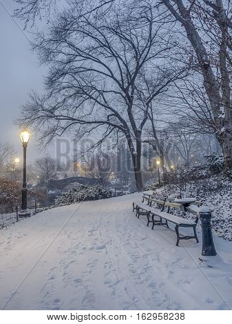 Gapstow Bridge is one of the icons of Central Park Manhattan in New York City during snow storm at night