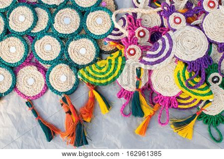Colorful doormats and coasters made of jute handicrafts on display during the Handicraft Fair in Kolkata earlier Calcutta West Bengal India. It is the biggest handicrafts fair in Asia.