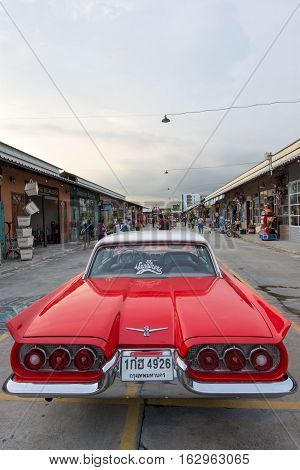 BANGKOK THAILAND - SEPTEMBER 17 2016: Old vintage red car at Night market Srinakarin road that name is train market. This market is open every Wednesday to sunday.