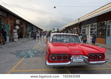 BANGKOK THAILAND - SEPTEMBER 17 2016: Old vintage red car at Night market Srinakarin road that name is train market. This market is open every Wednesday to sunday.
