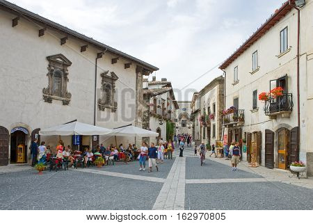 Pescocostanzo Italy - August 19 2006: Local people between the traditional architecture of the country center