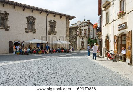 Pescocostanzo Italy - August 19 2006: Local people between the traditional architecture of the country center