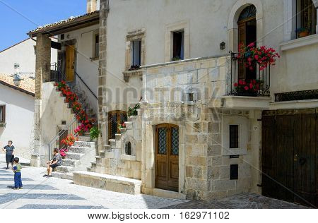 Pescocostanzo Italy - August 19 2006: Local people between the traditional architecture of the country center