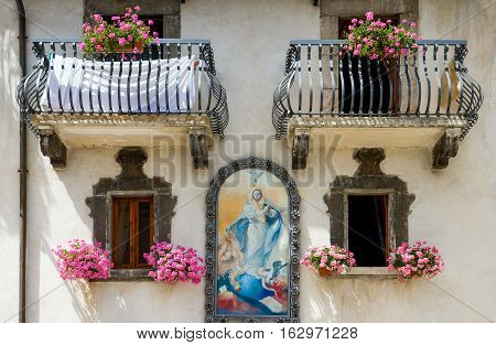 Pescocostanzo Italy - August 19 2006: A sacred painting on the facade of an house in the country center