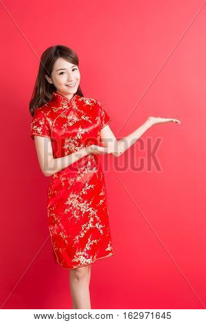 beauty woman wear cheongsam and show something to you in chinese new year