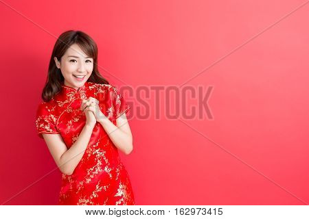 beauty woman wear cheongsam and smile to you in chinese new year