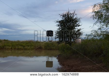 Sunrise over ranch pond and hunting blind in South Texas near Poteet.