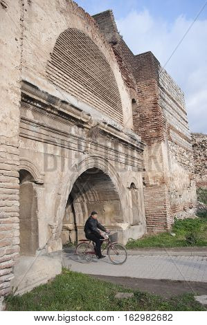 Iznik, Turkey - February 4, 2007: a man cycling in Roman Castle in Iznik (Nicea), Bursa