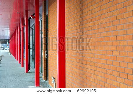 Architectural diversity in centre of resort Estonian town Parnu. Pedestrian gallery shopping complex the modern architecture of brick metal and glass. Brick texture old wall of red blocks