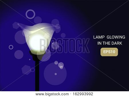 Vector illustration of a standing glowing lamp on a blue background EPS10