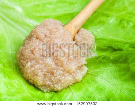 Herring Caviar In Wood Spoon On Green Lettuce