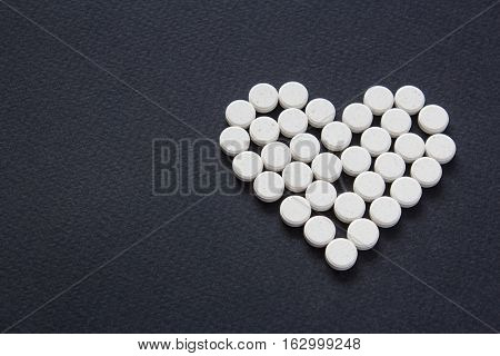 Meny different white pills. Medicine background from much capsules and pills. Drugstore set. Medicine Pills. heart
