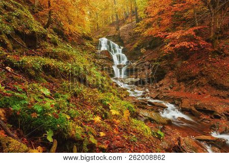 Beautiful Waterfall At Mountain River In Colorful Autumn Forest With Red And Orange Leaves At Sunset