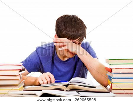 Tired Student Rub An Eyes On The School Desk Isolated On The White Background