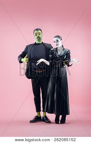 Halloween Family. Happy Couple In Halloween Costume And Makeup. Bloody Theme: The Crazy Maniak Faces