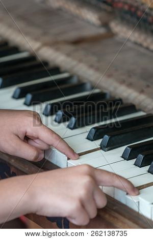 Close Up Of Hands Of A Little Girl Playing On The Piano
