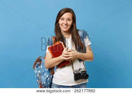 Portrait Of Young Pleasant Woman Student With Backpack And Retro Vintage Photo Camera On Neck Holdin