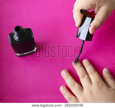 Children's Hands Paint Their Nails With Black Nail Polish. Children's Manicure. Black Manicure On Ch