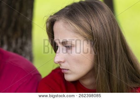 Close-up Profile Portrait Of Young Attractive Blond Long-haired Moody Unhappy Upset Thinking Woman C