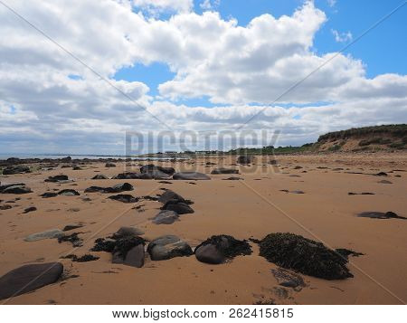 Brora Beach Sutherland Scotland With A Blue Sky And White Clouds