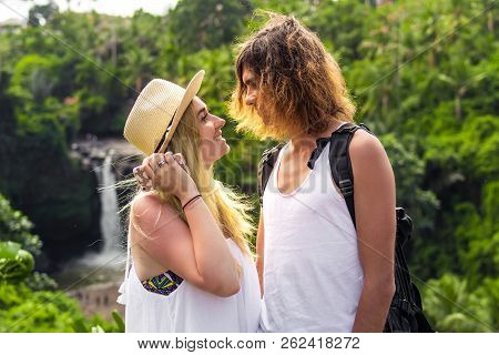 Young Honeymoon Couple In The Jungle On The Watefall Background. Bali Island.