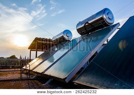 Water Panels For Using Renewable Sun Energy Are Placed On House Roof, Solar Hot Water System. Modern