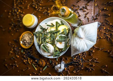 Close Up Of Organic Salad Of White Radish With Spring Onions,olive Oil,black Pepper,salt And Clove P