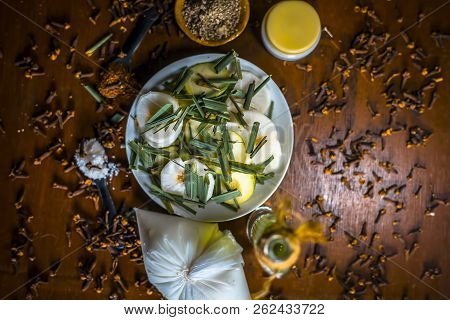 Close Up Of Organic Salad Of White Radish With Spring Onions,olive Oil,black Pepper,salt And Clove P