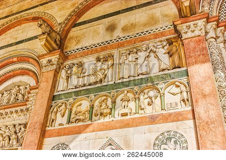 The Beautiful Decorations And Sculptures On The Wall Of The Portico Of Lucca Doumo, Italy
