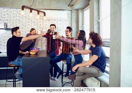 Friends Raised Their Hands Upwards With Cup.