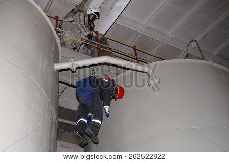 Surgutskaya GRES-2, Surgut, Russia, 24.07.2012. Rescue exercises at a chemical plant to rescue the victim. Training evacuation of the victim from a height. Rescuers of the fire department 134.