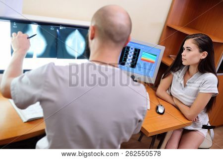 The Doctor And The Patient Are Watching A Mammogram