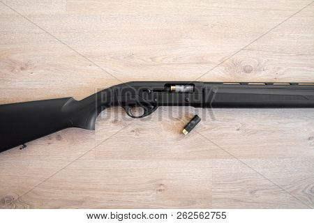 Semi-automatic Black Hunting Shotgun And Cartridges 12 Gauge, Close-up View