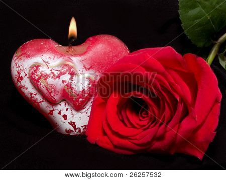 Valentýn-Zátiší s svíčka ve tvaru srdce a růže na černém pozadí. zaměřit se na 