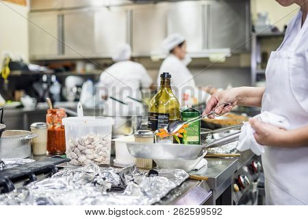 Kitchen Staff Busy With Preparing Food In Fancy Restaurant