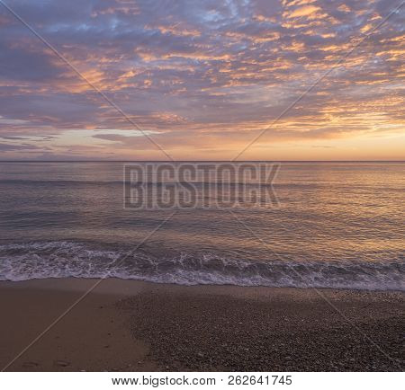 Beautiful Pastel Pink Orange And Golden Sunset Clouds And Waves At Sea Shore Agios Georgios Pagon Be