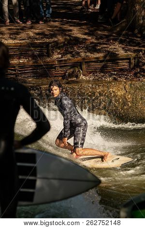 Munich, Germany - Sept 8, 2018: Man Surfing In The Waves Of The Eisbach River In Munich. It Forms A 
