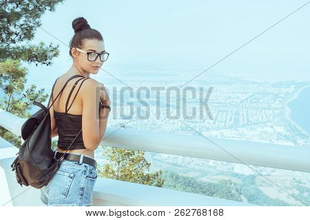 Fashion Young Girl With Backpack In Casual Clothes Glasses Enjoying A View From The Mountain To The 