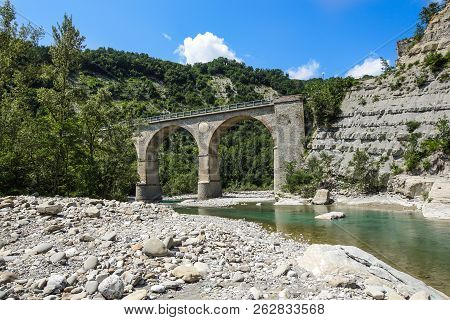 Old Historical Stone Bridge On River In The Mountains