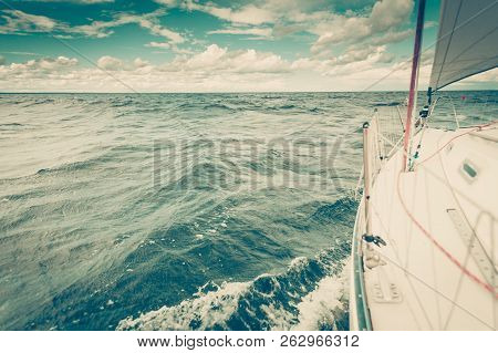 Yachting On Sail Boat Bow Stern Shot Splashing Sea Water. Sporty Transportation Conept.