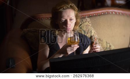 Woman With Computer, Drinking Beer At Home In The Dark.