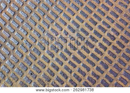 Extremely Close Up View Of Old Rusty Sewer Hatch On An Old Metal Plate. View From Above.