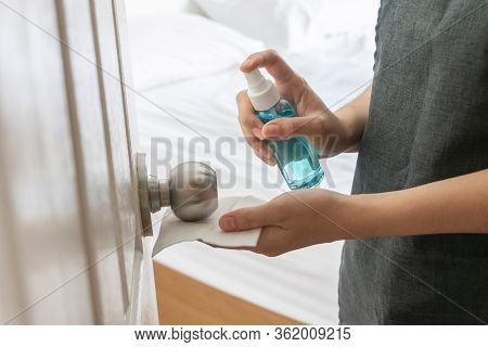 Hand Using Alcohol Sanitizer Or Spray On Door, Doorknob Bedroom For Prevent Coronavirus, Germs, Viru